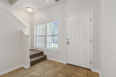 Foyer featuring stairway, plenty of natural light