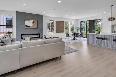 Living room with a fireplace, recessed lighting, 