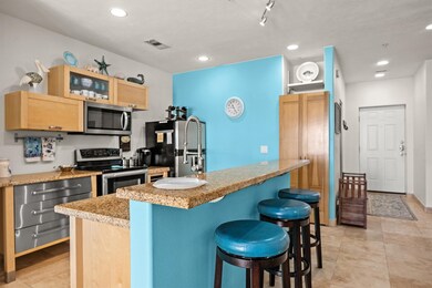 The modern kitchen features a breakfast bar that c