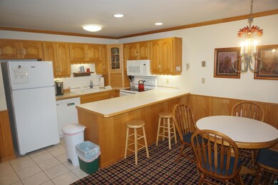 Kitchen featuring crown molding, white appliances,
