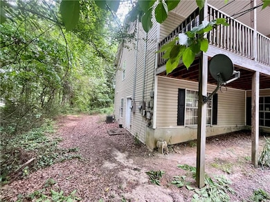 View of property exterior featuring a deck and coo