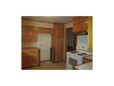 Kitchen has solid oak cabinetry with new stove and