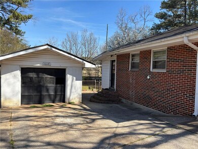 View of property exterior featuring driveway, a ga