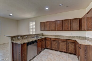 Kitchen featuring dishwasher, a sink, a peninsula,