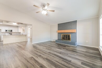 Unfurnished living room featuring dark wood-type f