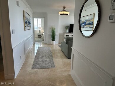 Corridor featuring crown molding, a wainscoted wal