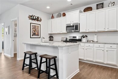 Kitchen with stainless steel appliances, a sink, d