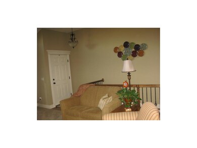 Living room towards front door, stairs to lower le
