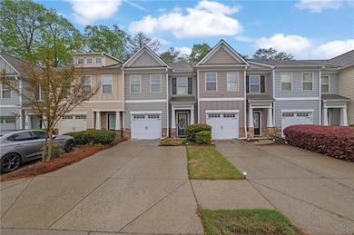 Townhome / multi-family property featuring a garag