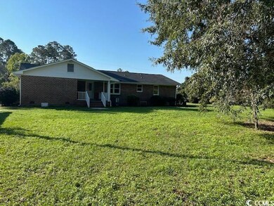 Rear view of property featuring a lawn
