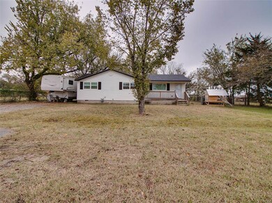 Back of house featuring a yard, crawl space, and a wooden deck