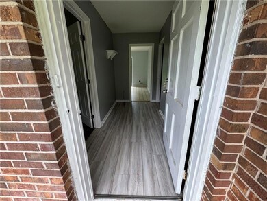 Doorway to property featuring brick siding