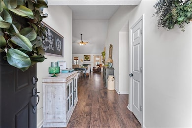Entrance foyer with a ceiling fan, a fireplace, ba
