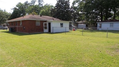 BACK YARD LOOKING AT SECOND FENCE AND GARAGE.
