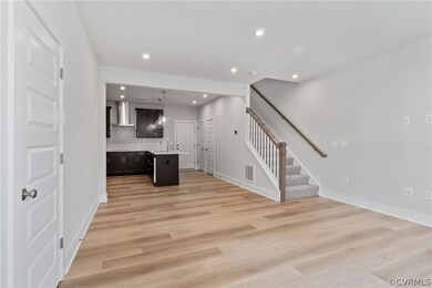 Unfurnished living room featuring sink and light w