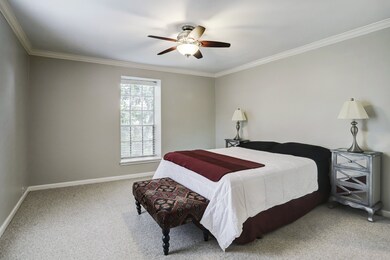 Spacious bedroom with two large windows and ceilin