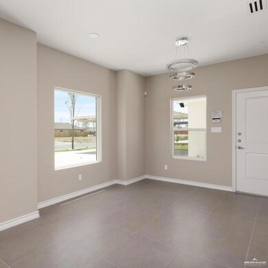 Unfurnished room featuring plenty of natural light and light tile patterned floors