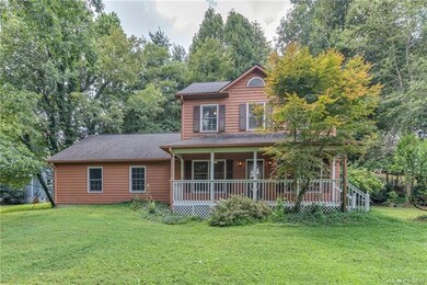 Spacious front yard and front of home with lovely covered porch