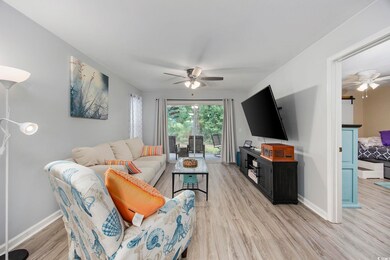 Living room featuring ceiling fan and light hardwo