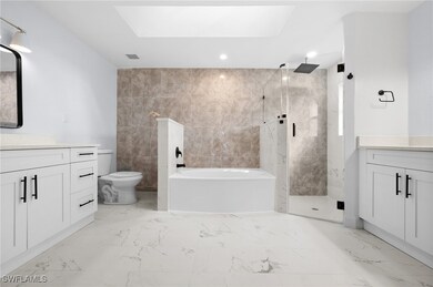 Full bathroom featuring a skylight, shower with se