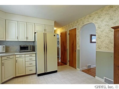 Kitchen. Arched doorway leads to the Dining Room..