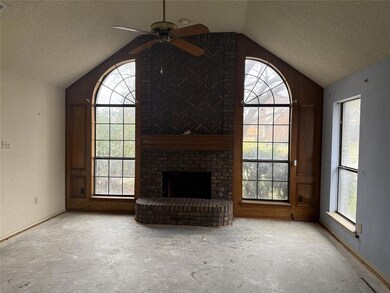 Unfurnished living room featuring ceiling fan, a f