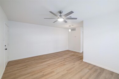 Spare room with a ceiling fan, light wood-type fl