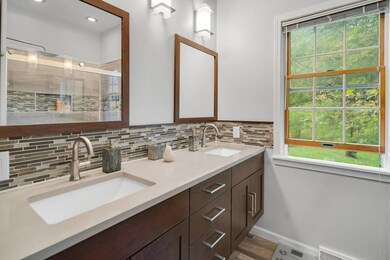 Main floor primary bath with double sinks and walk