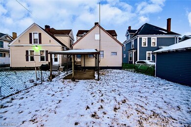 Snow covered back of property featuring a patio area