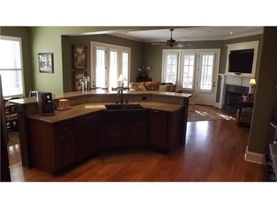 Hearth room with fireplace leading to screened por