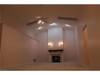 Open living/dining area with gas fireplace.  Offic