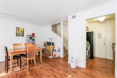 Dining room featuring a textured ceiling, stairwa