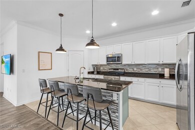 Kitchen with hanging light fixtures, sink, a kitch