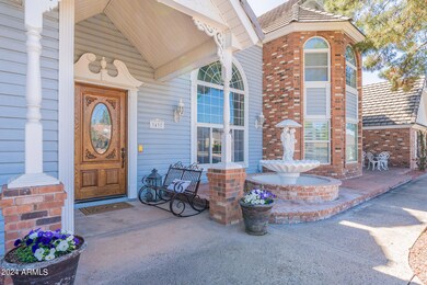 Covered front porch with fountain nearby