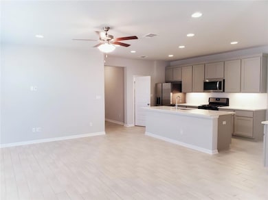 Kitchen with stainless steel appliances, gray cab