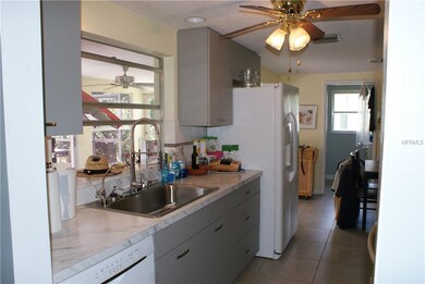Kitchen with pass through to enclosed Florida Room