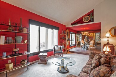 Living room featuring a chandelier, a textured cei