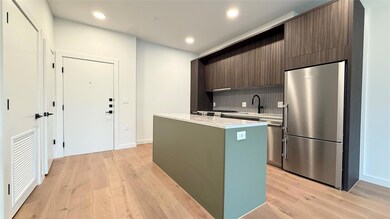 Kitchen with high end fridge, a center island, de
