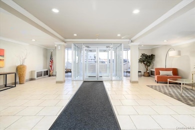 Lobby with crown molding and recessed lighting