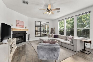 Living room with wood-type flooring, a ceiling fa