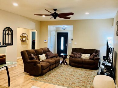 Large Open Inviting Living Room with decorative lighting and fan!