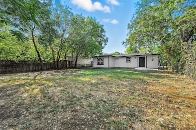Back of house with a fenced backyard