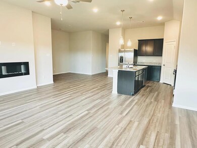 Kitchen featuring stainless steel fridge with ice 