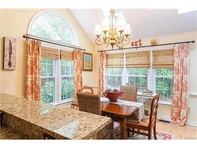 Sunny breakfast nook has vaulted ceiling and skyli