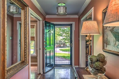Step inside to a handsomely decked out foyer. As you tour the home - you will feel a European influence in the overall design.  Terracotta floors, a black enamel front door, warm colored walls and pretty millwork set the stage.  Center hall opens to 
