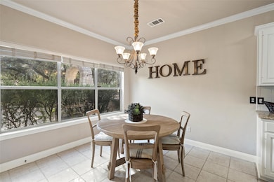 Dining space featuring crown molding, a chandelie