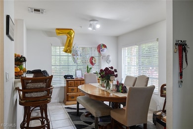 Dining space with light tile patterned floors