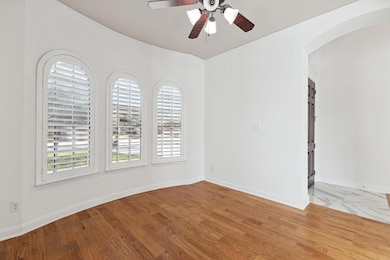 Formal living room featuring ceiling fan and light wood-type flooring