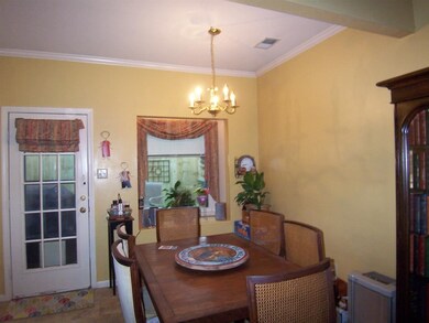 Spacious Dining Room with tile floor. Door leading