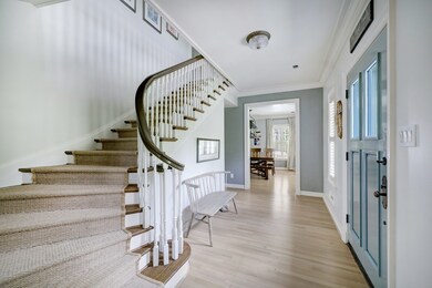 The sweeping staircase in the formal entry highlights the classic design of this 1930s River Oaks gem.
